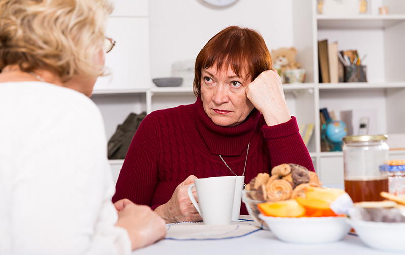 Woman listening to sibling about care for aging parents