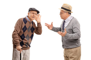 Senior hearing loss impacts two older men as they try to have a conversation.