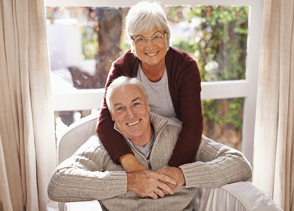 An older man and his wife smile as they discover home care as a means for avoiding a move to a nursing home.